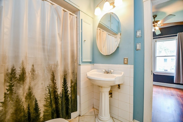 101 Emerald Ct, Houston, TX 77009 - full bath featuring tile walls, wainscoting, ceiling fan, and a shower with curtain