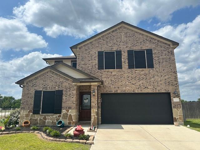 13010 Red Blossom Cir, Tomball, TX 77375 - view of front of home with brick siding, an attached garage, and driveway