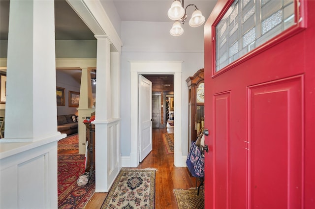 855 County Road 15, Damon, TX 77430 - entrance foyer with wood finished floors, decorative columns, and a chandelier