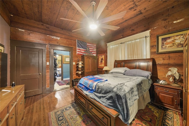 855 County Road 15, Damon, TX 77430 - bedroom with wood ceiling, wood walls, dark wood finished floors, and a ceiling fan