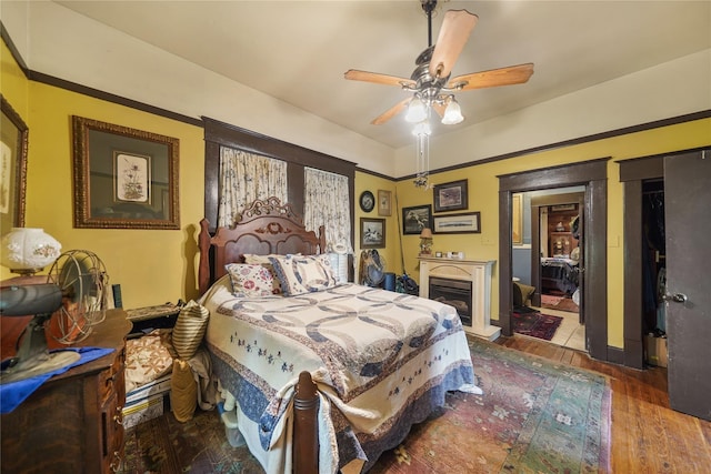 855 County Road 15, Damon, TX 77430 - bedroom with hardwood / wood-style floors, a fireplace, and ceiling fan