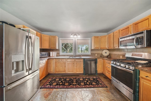 855 County Road 15, Damon, TX 77430 - kitchen featuring stainless steel appliances, a sink, backsplash, and light brown cabinetry