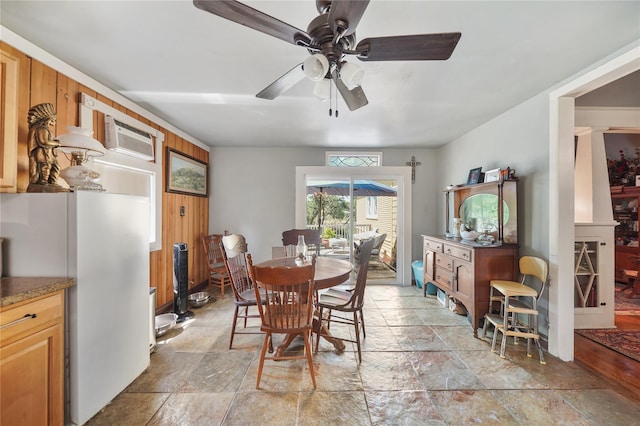 855 County Road 15, Damon, TX 77430 - dining space featuring stone tile flooring, a ceiling fan, and a wall mounted AC