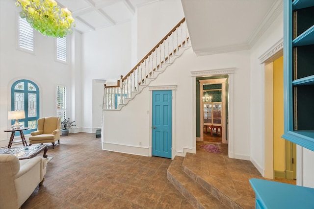 210 Victoria Way, Friendswood, TX 77546 - foyer with healthy amount of natural light, stairway, dark stone finish floors, beam ceiling, and crown molding