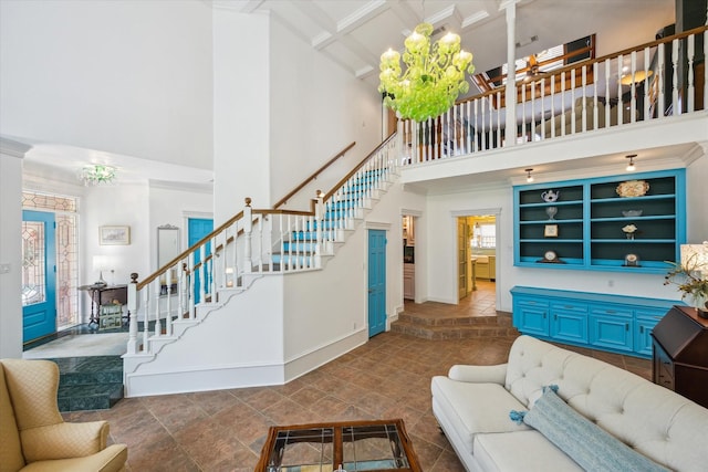 210 Victoria Way, Friendswood, TX 77546 - living room with a high ceiling, stairs, baseboards, beam ceiling, and ornamental molding