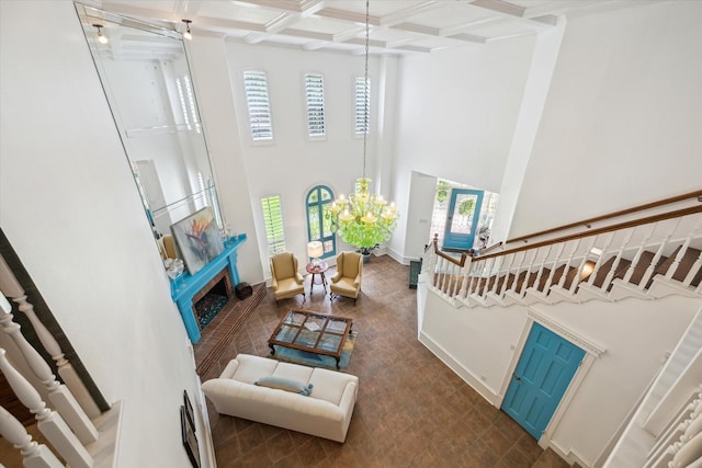 210 Victoria Way, Friendswood, TX 77546 - living area with a high ceiling, coffered ceiling, beam ceiling, stairs, and a fireplace