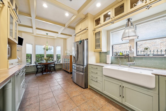 210 Victoria Way, Friendswood, TX 77546 - kitchen featuring stainless steel fridge, a sink, healthy amount of natural light, decorative backsplash, and beam ceiling