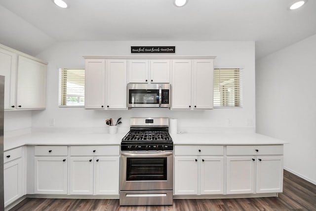 2947 Palominos Way, Conroe, TX 77301 - kitchen featuring stainless steel appliances, white cabinets, dark wood-style floors, lofted ceiling, and recessed lighting