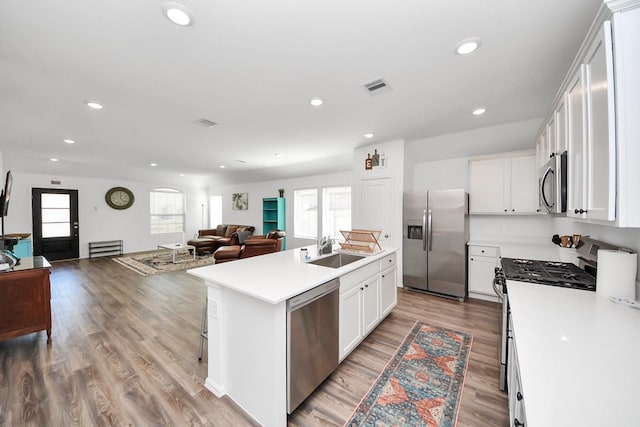 2947 Palominos Way, Conroe, TX 77301 - kitchen with appliances with stainless steel finishes, open floor plan, healthy amount of natural light, a sink, and recessed lighting