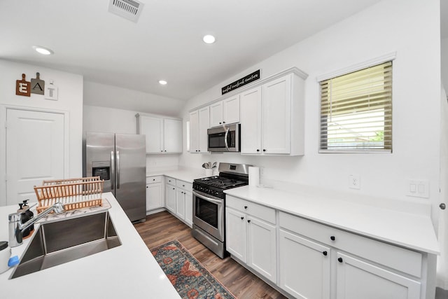 2947 Palominos Way, Conroe, TX 77301 - kitchen featuring stainless steel appliances, a sink, dark wood finished floors, white cabinetry, and recessed lighting