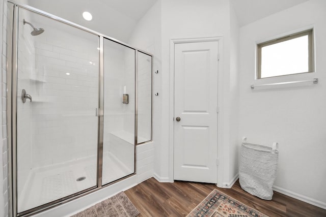 2947 Palominos Way, Conroe, TX 77301 - bathroom with a stall shower, wood finished floors, and baseboards