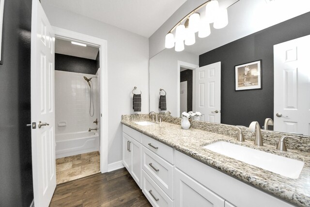 7519 Foster Creek Dr, Richmond, TX 77406 - bathroom featuring double vanity, shower / washtub combination, and wood finished floors