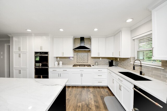 7519 Foster Creek Dr, Richmond, TX 77406 - kitchen featuring wall chimney exhaust hood, stainless steel appliances, crown molding, white cabinets, and recessed lighting