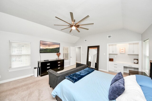 7519 Foster Creek Dr, Richmond, TX 77406 - bedroom featuring lofted ceiling, built in study area, light colored carpet, and ceiling fan