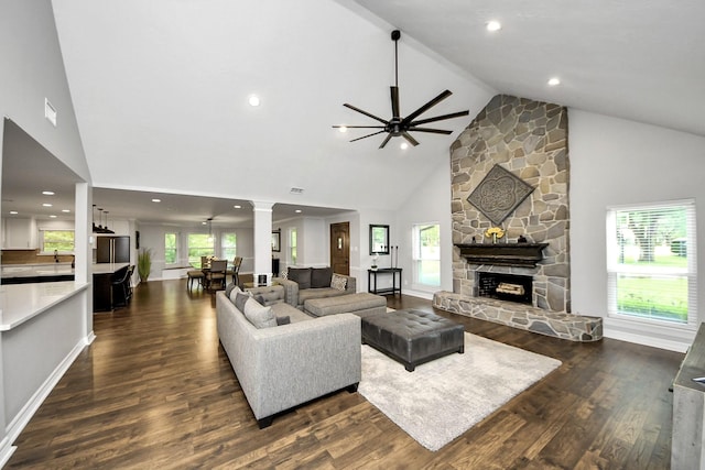 7519 Foster Creek Dr, Richmond, TX 77406 - living area with dark wood-type flooring, high vaulted ceiling, recessed lighting, a ceiling fan, and a stone fireplace