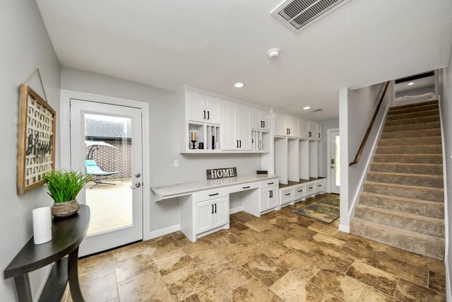 7519 Foster Creek Dr, Richmond, TX 77406 - mudroom with built in study area and light stone finish floors