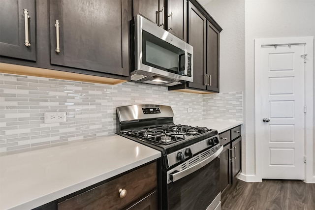 22107 Juniper Crossing Dr, New Caney, TX 77357 - kitchen featuring appliances with stainless steel finishes, dark wood finished floors, dark brown cabinets, and light countertops
