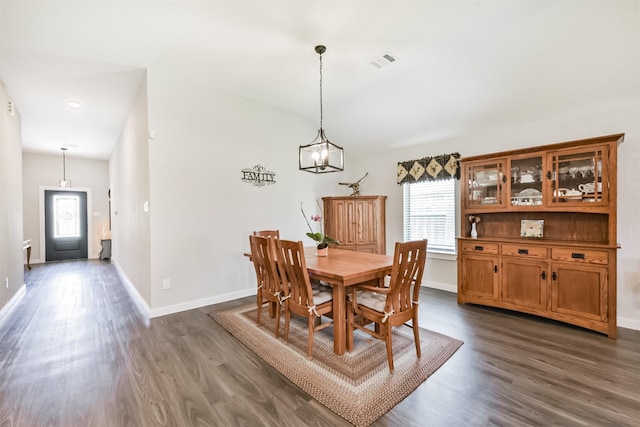 22107 Juniper Crossing Dr, New Caney, TX 77357 - dining area with healthy amount of natural light, dark wood finished floors, baseboards, and a chandelier