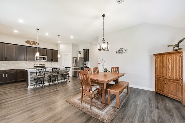 22107 Juniper Crossing Dr, New Caney, TX 77357 - dining room featuring dark wood-style floors, recessed lighting, lofted ceiling, and baseboards