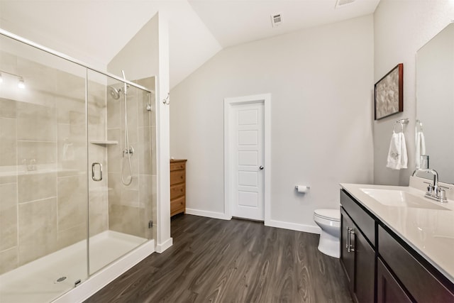 22107 Juniper Crossing Dr, New Caney, TX 77357 - full bathroom with vanity, a shower stall, wood finished floors, toilet, and lofted ceiling
