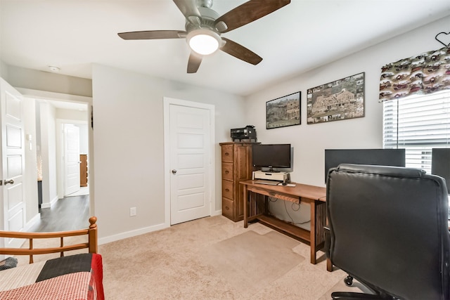 22107 Juniper Crossing Dr, New Caney, TX 77357 - home office with light colored carpet, ceiling fan, and baseboards