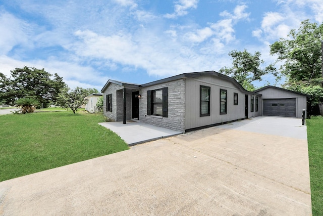 503 Schilling St, Baytown, TX 77520 - view of front facade with driveway, stone siding, an outdoor structure, a front lawn, and an attached garage