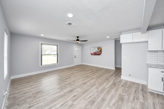 503 Schilling St, Baytown, TX 77520 - unfurnished living room featuring a ceiling fan, light wood-style flooring, recessed lighting, baseboards, and a textured ceiling