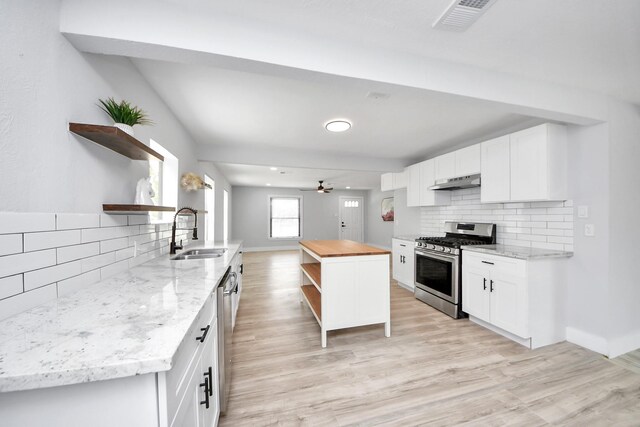 503 Schilling St, Baytown, TX 77520 - kitchen with open shelves, a sink, stainless steel appliances, and decorative backsplash