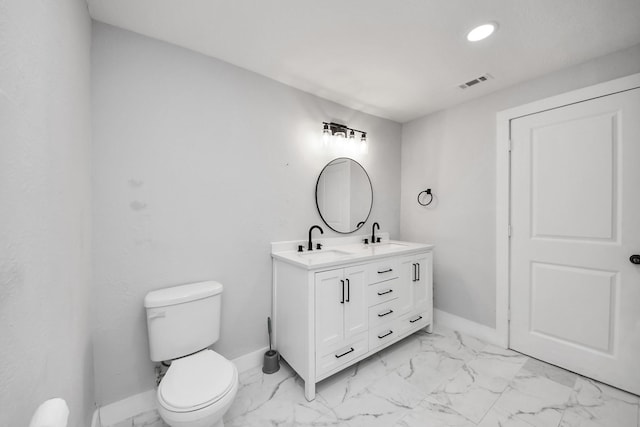503 Schilling St, Baytown, TX 77520 - full bathroom featuring baseboards, marble finish floors, double vanity, toilet, and recessed lighting