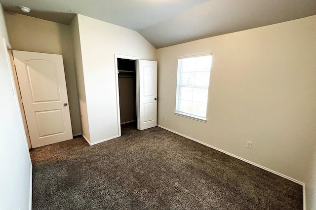 22911 San Giorgio Ct, Katy, TX 77449 - unfurnished bedroom featuring lofted ceiling, dark carpet, baseboards, and a closet