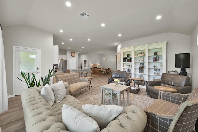 9203 White Tail Dr, Conroe, TX 77303 - living area featuring light wood-type flooring, recessed lighting, and vaulted ceiling