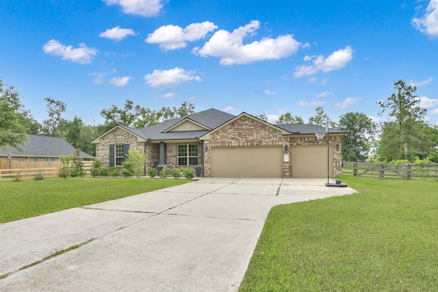 9203 White Tail Dr, Conroe, TX 77303 - view of front facade featuring concrete driveway, an attached garage, stone siding, and a shingled roof
