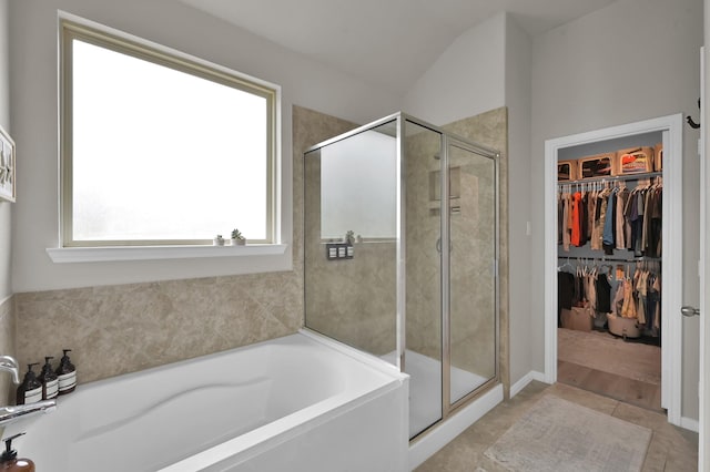 9203 White Tail Dr, Conroe, TX 77303 - full bathroom featuring a garden tub, a stall shower, a spacious closet, and tile patterned flooring