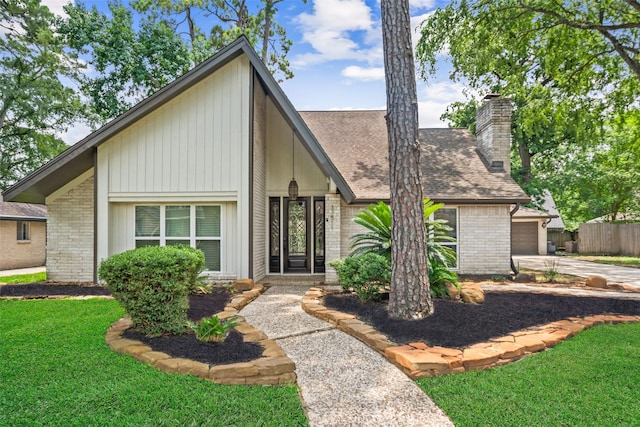 17511 Cassina Dr, Spring, TX 77388 - mid-century inspired home featuring brick siding, a chimney, an attached garage, driveway, and a shingled roof
