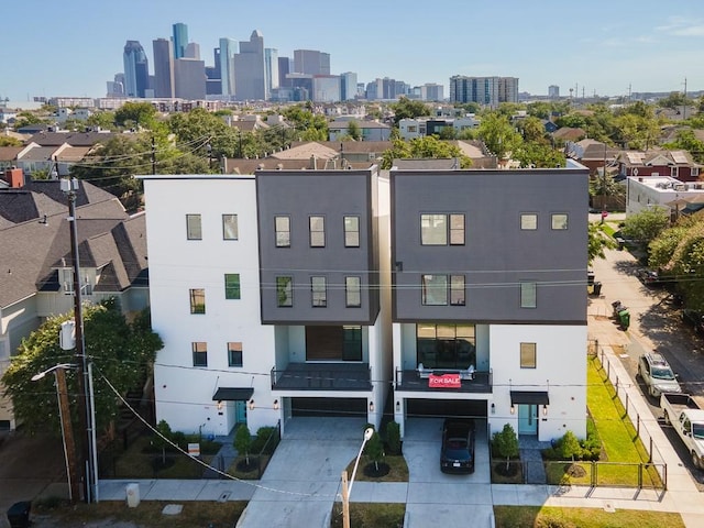 2209 Crocker St, Houston, TX 77006 - view of property with an attached garage and a view of skyline