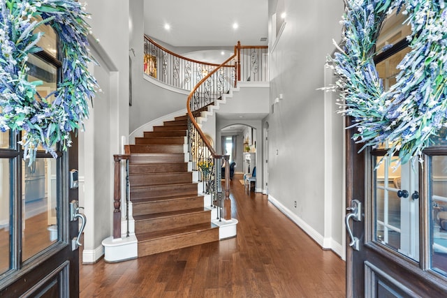 72 Tall Trl, Missouri City, TX 77459 - entryway with a towering ceiling, arched walkways, wood finished floors, stairway, and recessed lighting