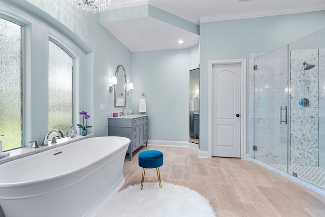 72 Tall Trl, Missouri City, TX 77459 - full bathroom with vanity, a shower stall, a freestanding tub, crown molding, and a chandelier