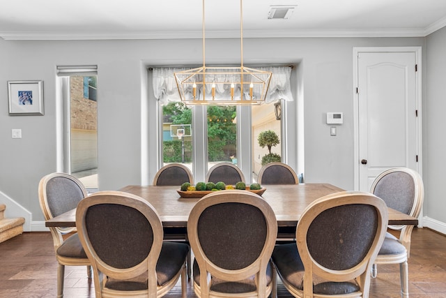 72 Tall Trl, Missouri City, TX 77459 - dining area featuring ornamental molding, a chandelier, wood finished floors, and stairway