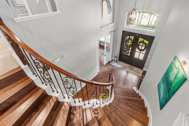 72 Tall Trl, Missouri City, TX 77459 - entryway featuring hardwood / wood-style flooring, a chandelier, a high ceiling, and stairway
