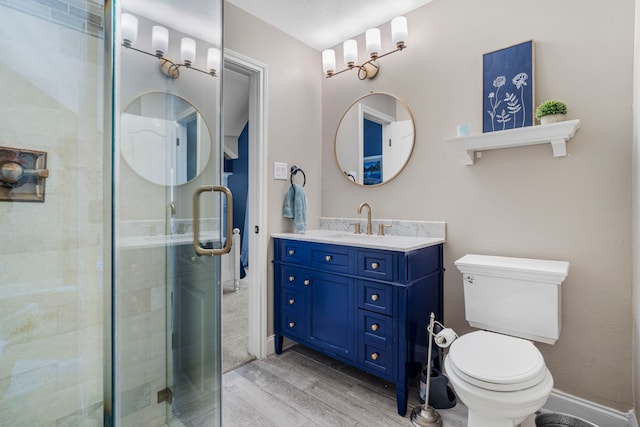 72 Tall Trl, Missouri City, TX 77459 - full bath with vanity, toilet, a shower stall, and wood finished floors