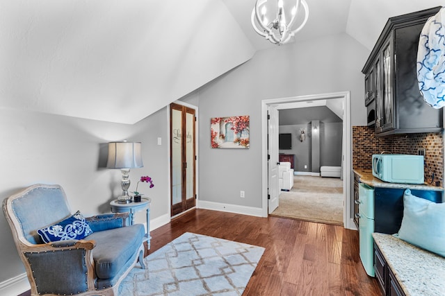 72 Tall Trl, Missouri City, TX 77459 - sitting room with vaulted ceiling, wood finished floors, and a chandelier