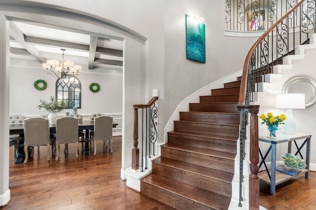 72 Tall Trl, Missouri City, TX 77459 - stairway with beam ceiling, a chandelier, wood finished floors, and coffered ceiling