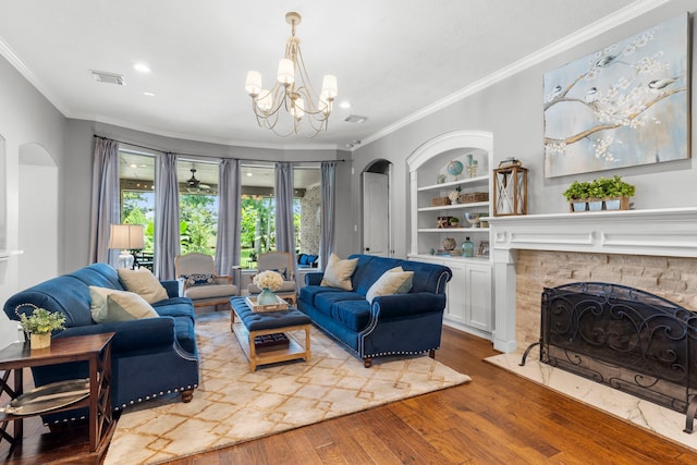 72 Tall Trl, Missouri City, TX 77459 - living area with ornamental molding, wood finished floors, arched walkways, a chandelier, and a fireplace