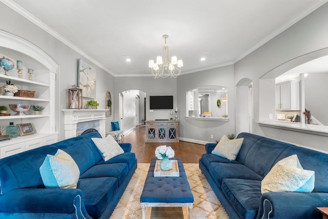 72 Tall Trl, Missouri City, TX 77459 - living room with arched walkways, recessed lighting, wood finished floors, a chandelier, and crown molding