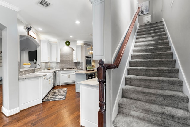 72 Tall Trl, Missouri City, TX 77459 - kitchen with gas cooktop, stainless steel oven, dark wood-style flooring, white cabinetry, and backsplash
