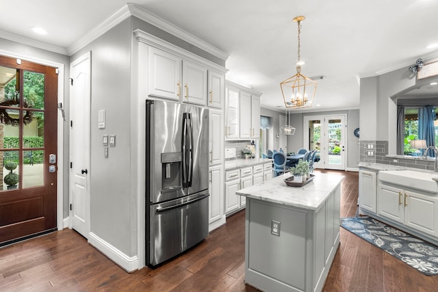 72 Tall Trl, Missouri City, TX 77459 - kitchen with stainless steel fridge, a center island, white cabinets, backsplash, and recessed lighting