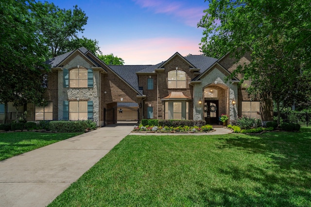 72 Tall Trl, Missouri City, TX 77459 - view of front of home featuring a gate, a front yard, and brick siding