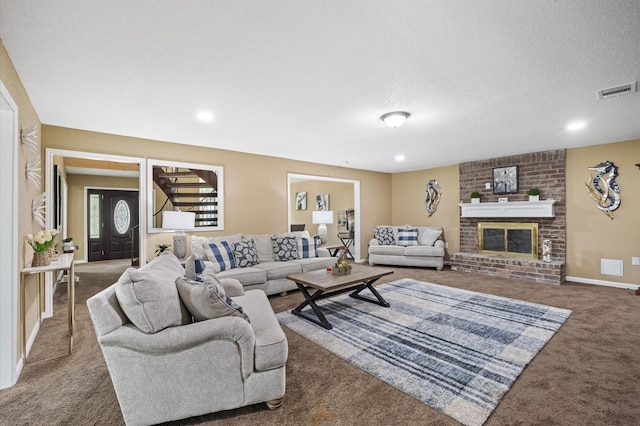 20407 Spoonwood Dr, Humble, TX 77346 - carpeted living room featuring a fireplace, a textured ceiling, recessed lighting, and baseboards