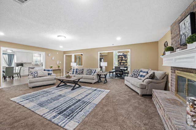 20407 Spoonwood Dr, Humble, TX 77346 - living area featuring carpet, a textured ceiling, and a fireplace
