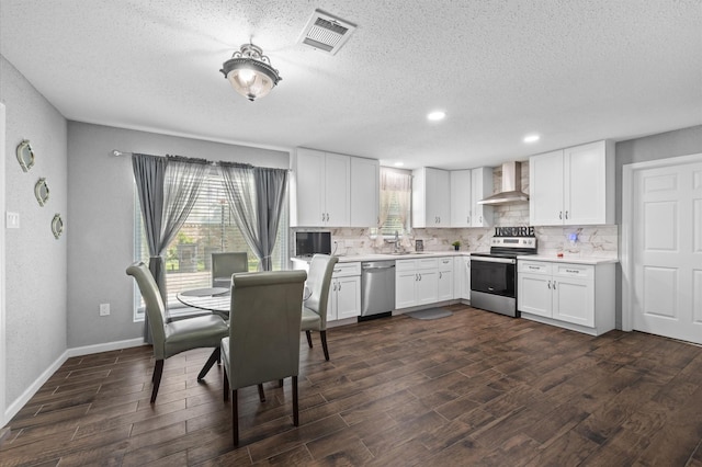 20407 Spoonwood Dr, Humble, TX 77346 - kitchen with stainless steel appliances, wall chimney exhaust hood, dark wood-style floors, light countertops, and decorative backsplash